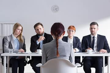 51793960 - woman during job interview and four elegant members of management